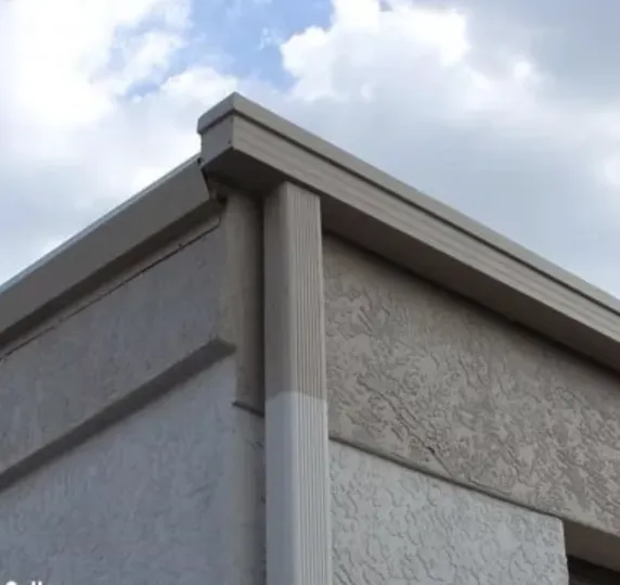 Close up of seamless gutter corner and downspout